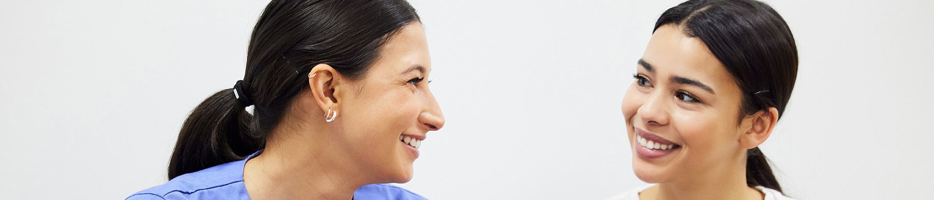 The image shows a modern dental clinic interior with various pieces of equipment, including a dental chair and an X-ray machine.